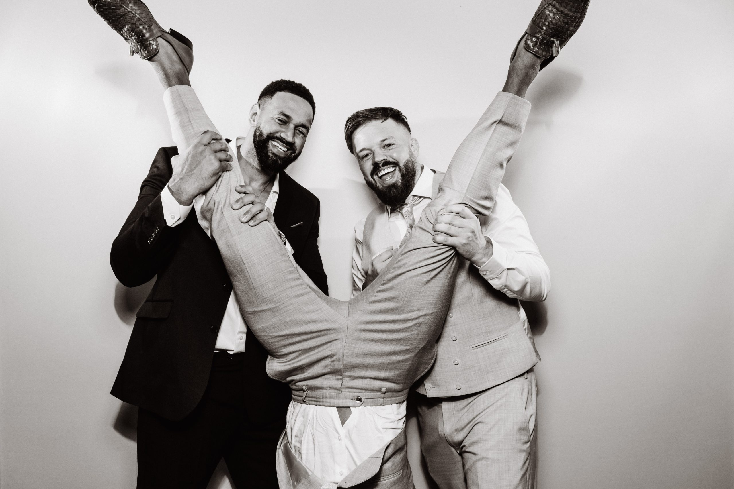 Booth print of two wedding guests in suits jumping for the camera